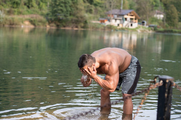 Attractive Man Washing His Face In River