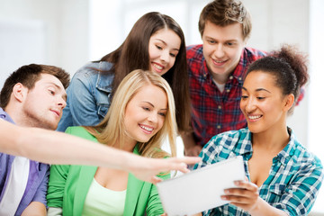 students looking at tablet pc at school
