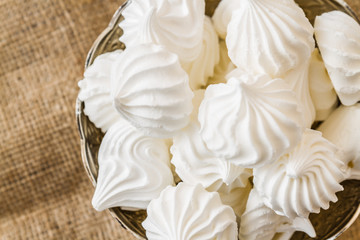  Small white meringue cookies in a bowl  - obrazy, fototapety, plakaty