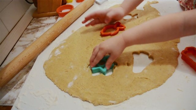 Cooking children are making cookies in the kitchen