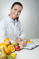 Smiling nutritionist writing medical records