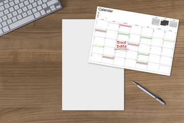 Calendar Due Date and blank sheet on wooden Table