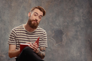 Young creative man posing with notes