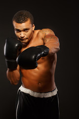 Fototapeta na wymiar Handsome boxer posing in boxing gloves
