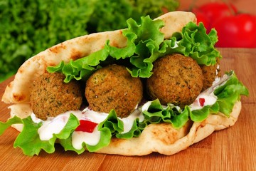 Falafel with vegetables and  tzatziki sauce in pita bread