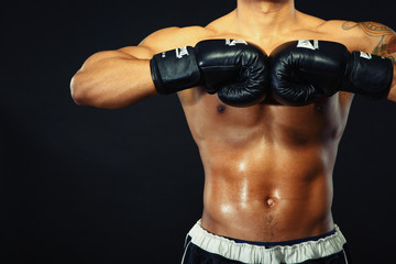 Fototapeta na wymiar Handsome boxer posing in boxing gloves