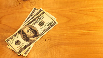 USD bills on wood surface