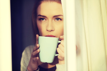 Beautiful woman drinking hot coffee or tea.