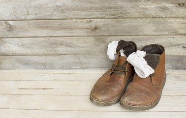 Still Life brown leather men's boots on wood background