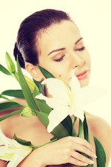 Beautiful topless woman with white lily.