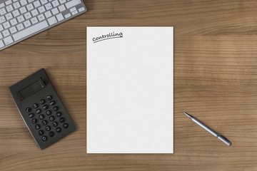 Blank sheet Controlling on a wooden table with calculator