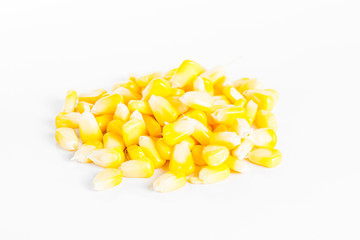 Pile of yellow corn kernels isolated on white background