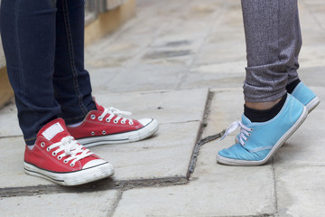 men and women legs wearing sneakers.