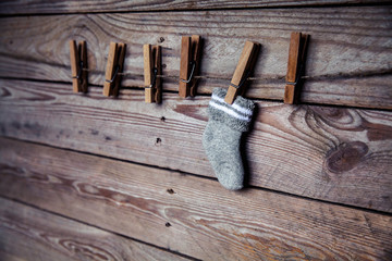 gray sock with a clothespin on a wooden background