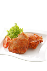 close up two chicken fried on white dish