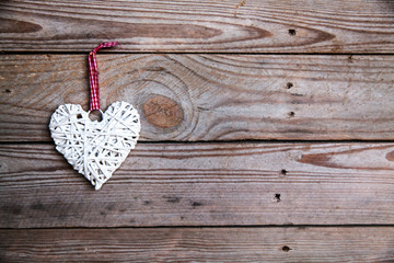 White heart on a wooden background.