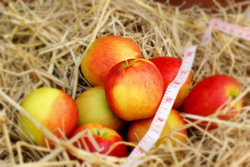 measure tape and red apple