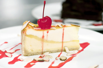 Slice Cheesecake with raspberry and nut on top