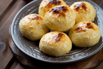 Ceramic plate with freshly made curd pancakes, close-up