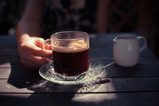 Young woman drinking coffee outside