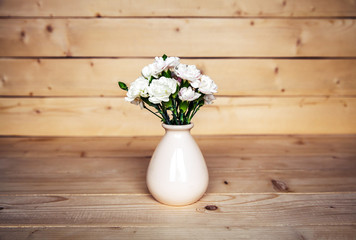delicate bouquet of carnations in vintage vase with heart on woo