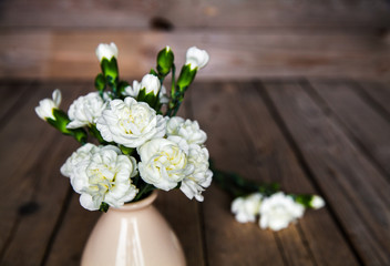 delicate bouquet of carnations in vintage vase with heart
