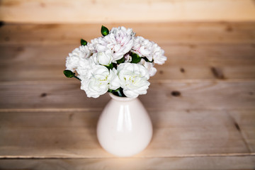 delicate bouquet of carnations in vintage vase with heart