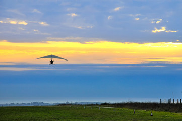 Fototapeta na wymiar motor hang glider in the cloudy sunset