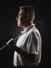 Mature man golfer and golf club