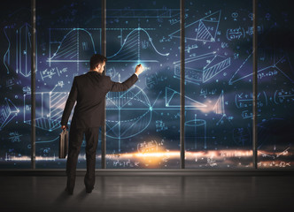 Businessman drawing business graphs