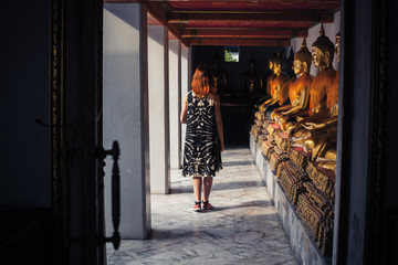 Fototapeta na wymiar Woman exploring buddhist temple