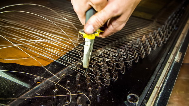 Dismantling Process of Old Piano Strings With Pliers