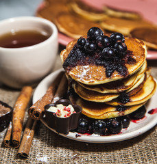Picture of few pancakes with blackberries and sugar