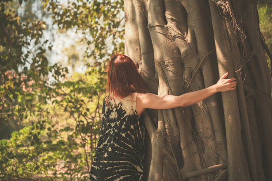 Woman hugging a giant tree