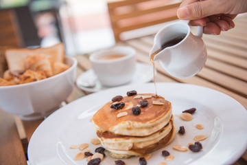 pour pure honey into pancake