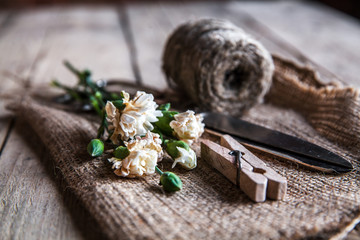 Faded carnations with old scissors and old thread, vintage