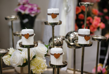 white candles with a heart with knitted texture