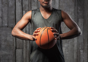 Afro-american basketball athlete gripping the ball