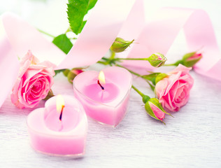 Fototapeta na wymiar Valentines Day. Pink heart shaped candles and rose flowers