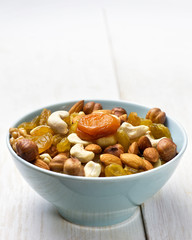 nuts and dried fruits in a blue cup