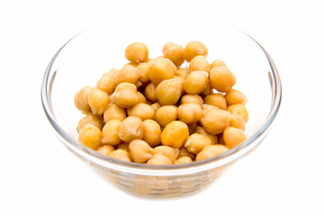 Chickpeas on glass bowl on white background