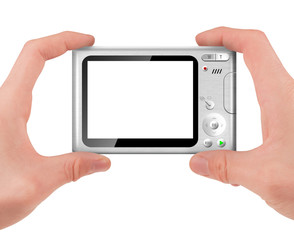 Hand holding a compact digital camera with empty LCD screen