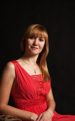 Fototapeta premium portrait of a beautiful woman in a red dress