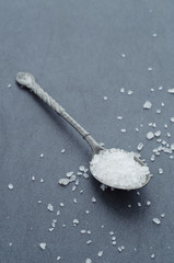 Closeup of a metal spoon with salt