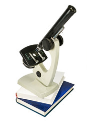 microscope and books isolated on white