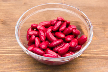 Red beans on bowl on wooden table