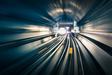 Subway tunnel with blurred light tracks with arriving train