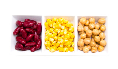 Tris of cooked vegetables on a white background seen from above