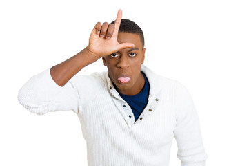 funny young man showing loser sign on his forehead