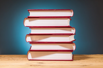 pile of  books on wooden table